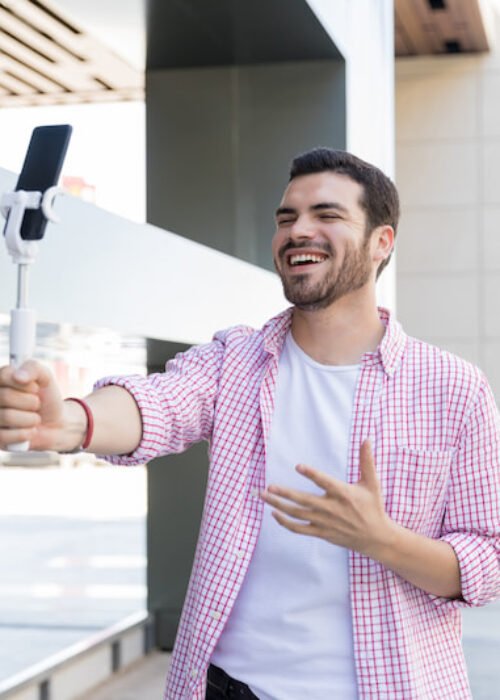 happy-blogger-recording-live-video-on-smartphone-at-shopping-mall (1)