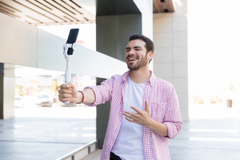 happy-blogger-recording-live-video-on-smartphone-at-shopping-mall (1)
